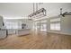 Open-concept kitchen flows to the living area with large windows and natural light at 4010 Herblinda Ln, North Las Vegas, NV 89032