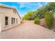 House backyard with gravel and surrounding trees at 4360 Meadowlark Wing Way, North Las Vegas, NV 89084