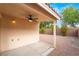 Backyard patio with ceiling fan and gravel yard at 4360 Meadowlark Wing Way, North Las Vegas, NV 89084