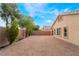 A spacious backyard featuring a neutral rock ground cover and a well-maintained block wall, perfect for outdoor entertaining at 4360 Meadowlark Wing Way, North Las Vegas, NV 89084