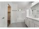 Clean white bathroom features granite counters, tile floors, and tub-shower at 4360 Meadowlark Wing Way, North Las Vegas, NV 89084