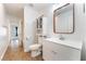 Bright bathroom with white cabinets and a wood trimmed mirror at 4360 Meadowlark Wing Way, North Las Vegas, NV 89084