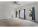 Bright, carpeted bedroom with an ensuite bathroom and high ceilings at 4360 Meadowlark Wing Way, North Las Vegas, NV 89084