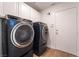 Modern laundry room with front-load washer and dryer at 4360 Meadowlark Wing Way, North Las Vegas, NV 89084