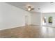 Spacious living room with wood-look tile flooring and access to the backyard through glass doors at 4360 Meadowlark Wing Way, North Las Vegas, NV 89084