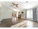 Bright living room featuring a fireplace, ceiling fan, and french doors to the backyard at 4360 Meadowlark Wing Way, North Las Vegas, NV 89084