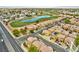 Scenic aerial view of neighborhood homes, pond, and golf course in a well-planned community at 5774 Typecast Rd, Las Vegas, NV 89142