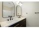 Bathroom features dual sinks, modern fixtures, and a black framed mirror at 5774 Typecast Rd, Las Vegas, NV 89142
