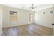 Spacious bedroom with wood floors and a modern light fixture at 5774 Typecast Rd, Las Vegas, NV 89142