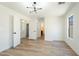 Large bedroom with stylish light fixture and wood flooring at 5774 Typecast Rd, Las Vegas, NV 89142