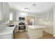 Updated kitchen with island, stainless steel appliances, and light gray cabinets at 5774 Typecast Rd, Las Vegas, NV 89142