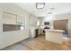 Bright kitchen featuring white cabinets, stainless steel appliances, and a center island with a breakfast bar at 5774 Typecast Rd, Las Vegas, NV 89142