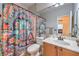 Bathroom with bright colorful curtain and sink with vanity at 664 Blue Crystal Creek Rd, Henderson, NV 89002