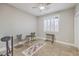 Bright bedroom features neutral walls, shuttered window, ceiling fan, and tile flooring at 664 Blue Crystal Creek Rd, Henderson, NV 89002