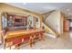 Open-concept dining area with a rustic wooden table and seamless connection to the living room and staircase at 664 Blue Crystal Creek Rd, Henderson, NV 89002