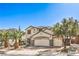 Beautiful two-story home with a three-car garage, complemented by well-manicured landscaping and mature trees at 664 Blue Crystal Creek Rd, Henderson, NV 89002