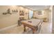 Entertaining game room featuring billiard table, neutral walls, travertine floors and ample seating at 664 Blue Crystal Creek Rd, Henderson, NV 89002