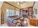 Inviting living room featuring a fireplace, built-in shelves, and a comfortable brown sectional sofa at 664 Blue Crystal Creek Rd, Henderson, NV 89002