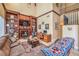 Cozy living room with a fireplace, built-in shelving, and a sectional sofa beneath a soaring ceiling at 664 Blue Crystal Creek Rd, Henderson, NV 89002