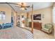 Cozy main bedroom with four poster bed, ceiling fan, and tiled floor at 664 Blue Crystal Creek Rd, Henderson, NV 89002