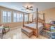 Cozy main bedroom with four poster bed, ceiling fan, and tiled floor at 664 Blue Crystal Creek Rd, Henderson, NV 89002