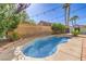 Relaxing backyard pool with brick accents, tall palm trees, and an artistic mural on the fence at 664 Blue Crystal Creek Rd, Henderson, NV 89002