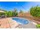 Inviting backyard pool surrounded by a concrete patio, lush landscaping, and overhead string lights at 664 Blue Crystal Creek Rd, Henderson, NV 89002