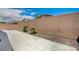 Private backyard features a paved area, rock detail, and block wall at 7822 Whitlocks Mill Ave, Las Vegas, NV 89147