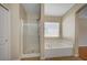 Bathroom showcasing a shower and soaking tub with window at 7822 Whitlocks Mill Ave, Las Vegas, NV 89147