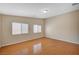 Bedroom featuring laminate flooring, neutral paint, and two windows at 7822 Whitlocks Mill Ave, Las Vegas, NV 89147