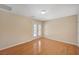 Bright bedroom features wood floors and door to outdoor area, creating a seamless indoor-outdoor flow at 7822 Whitlocks Mill Ave, Las Vegas, NV 89147