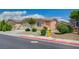 Inviting single-story home with a two-car garage, xeriscaping, a yellow fire hydrant and concrete walkway at 7822 Whitlocks Mill Ave, Las Vegas, NV 89147