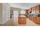 Well-lit kitchen boasting wood cabinets, tile backsplash, stainless steel appliances, and a center island at 7822 Whitlocks Mill Ave, Las Vegas, NV 89147