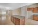 Bright and open kitchen showcasing an island with granite countertops and tile floors at 7822 Whitlocks Mill Ave, Las Vegas, NV 89147