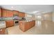 Open kitchen with island, tile floors, stainless steel appliances, and view to living area at 7822 Whitlocks Mill Ave, Las Vegas, NV 89147