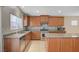 Spacious kitchen featuring an island, granite counters, stainless appliances, and tile backsplash at 7822 Whitlocks Mill Ave, Las Vegas, NV 89147