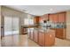 Bright kitchen featuring an island, granite countertops, tile backsplash, and stainless steel appliances at 7822 Whitlocks Mill Ave, Las Vegas, NV 89147