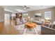 Bright living room showcases an open floor plan, large windows, and a ceiling fan at 7822 Whitlocks Mill Ave, Las Vegas, NV 89147