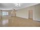 Expansive living room featuring tile flooring, neutral paint, and modern lighting fixtures at 7822 Whitlocks Mill Ave, Las Vegas, NV 89147