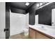 Bathroom with a dark accent wall, white tiles, wood vanity, and a shower/tub combo at 921 Sulphur Springs Ln # 201, Las Vegas, NV 89128