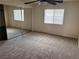 Bedroom with sliding mirror door closet, ceiling fan, and window at 921 Sulphur Springs Ln # 201, Las Vegas, NV 89128