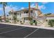 Low-rise residential building featuring stucco siding, private balconies and assigned parking in a gated community at 921 Sulphur Springs Ln # 201, Las Vegas, NV 89128