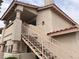 Two-story exterior of home with balcony, and stairs to front entrance at 921 Sulphur Springs Ln # 201, Las Vegas, NV 89128