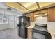 Bright kitchen featuring modern appliances, wood cabinets, lots of natural light, and a view of dining area at 921 Sulphur Springs Ln # 201, Las Vegas, NV 89128