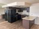 This kitchen features a refrigerator, oven, countertop, and dark colored cabinetry at 921 Sulphur Springs Ln # 201, Las Vegas, NV 89128