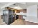 Functional kitchen with ample counter space, sleek black appliances and wood-look floors at 921 Sulphur Springs Ln # 201, Las Vegas, NV 89128