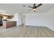 Open-concept living room and kitchen area with wood-look floors and a ceiling fan at 921 Sulphur Springs Ln # 201, Las Vegas, NV 89128