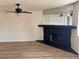 Living room featuring a black fireplace, wood floors, and a ceiling fan at 921 Sulphur Springs Ln # 201, Las Vegas, NV 89128
