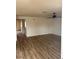 Bright living room featuring new laminate floors and a ceiling fan at 921 Sulphur Springs Ln # 201, Las Vegas, NV 89128