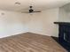 Spacious living room features modern floors, a ceiling fan, and stone fireplace at 921 Sulphur Springs Ln # 201, Las Vegas, NV 89128
